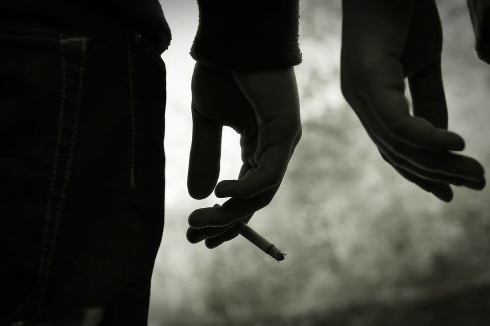 Young people's hands with cigarettes