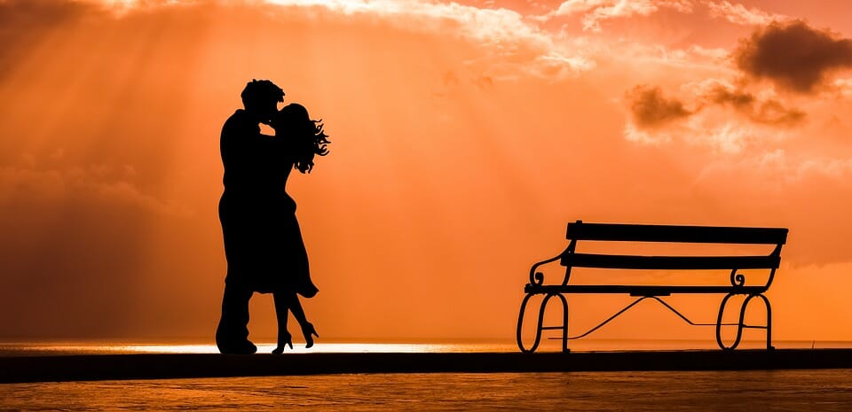 Couple kissing at sunset