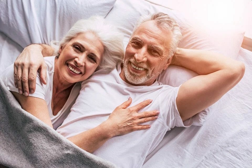Happy older couple in bed