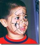 Little boy with spider web drawn on his face