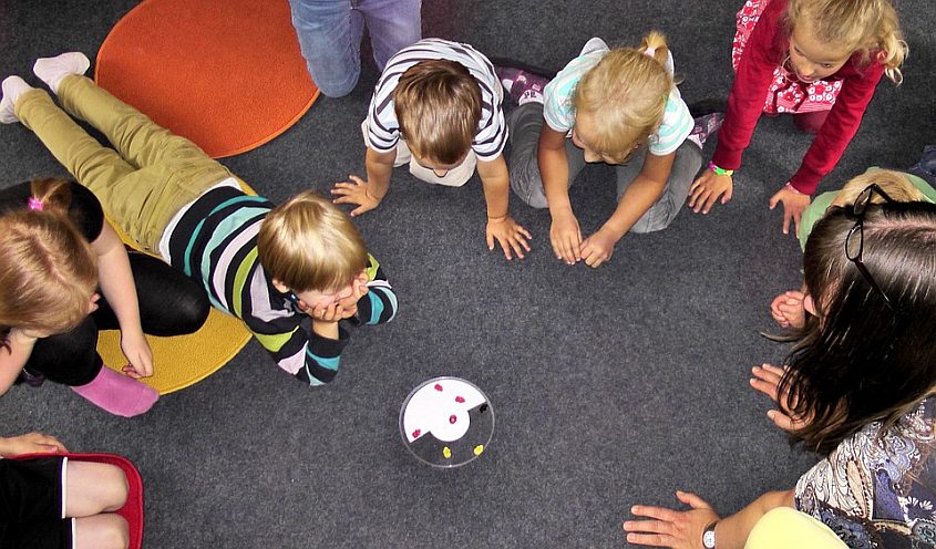 Kids playing a game on the floor