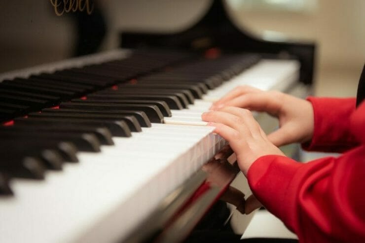 Auditory child's hands playing piano