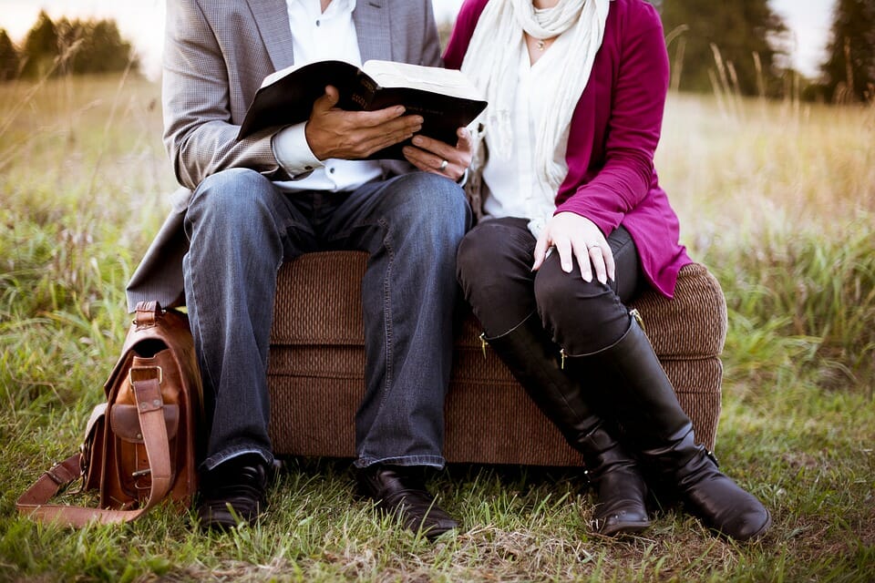 Couple sitting and reading a book together