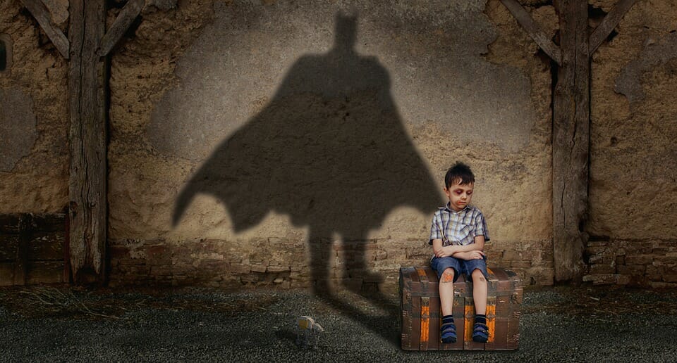 Boy casting a Batman shadow