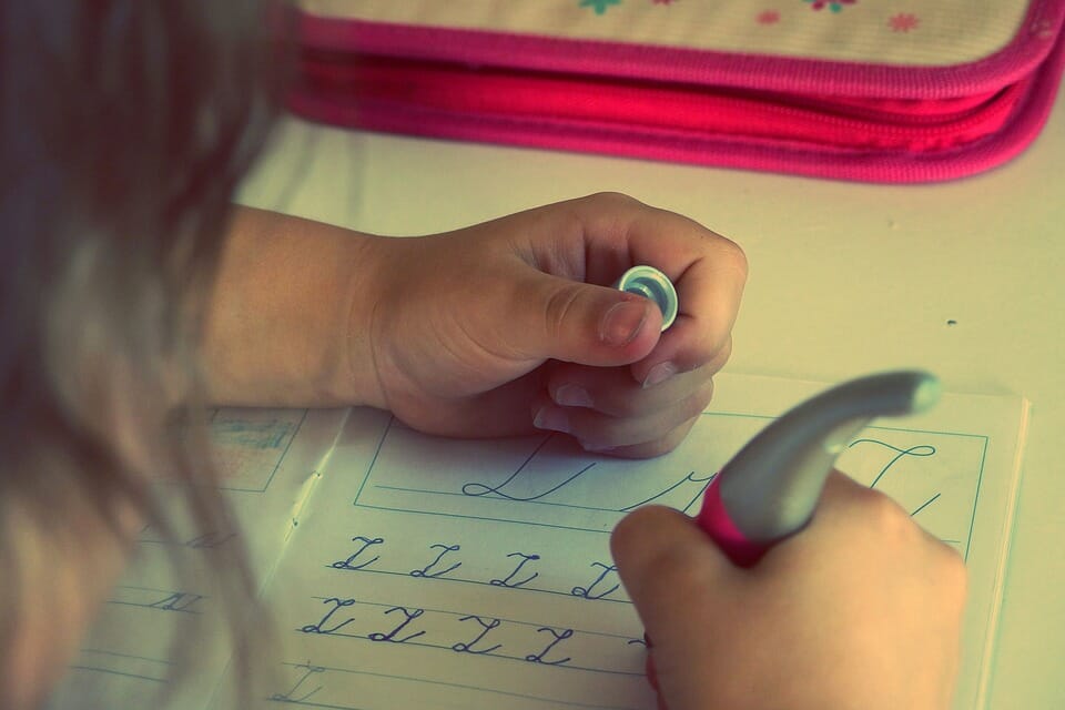 Girl practicing writing letters