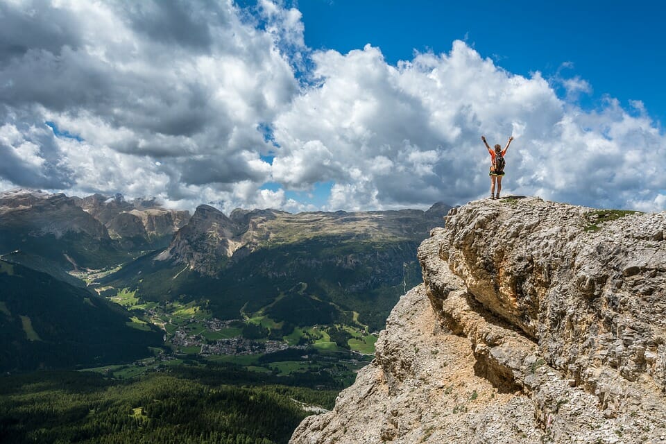 Person standing on top of a mountain