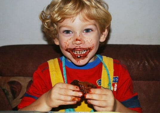 Happy boy eating chocolate