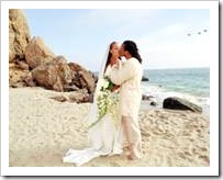 Bride and groom kissing on a beach