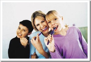 Mother, son and daughter brushing their teeth