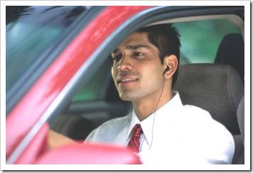 Man with ear piece in a car
