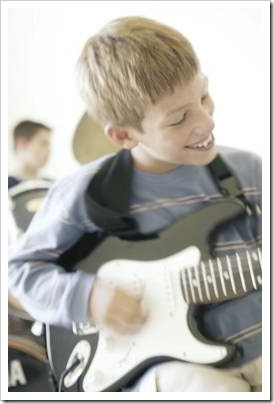 Boy playing electric guitar