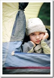 Girl lying down in a tent