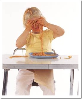 Boy playing with spaghetti