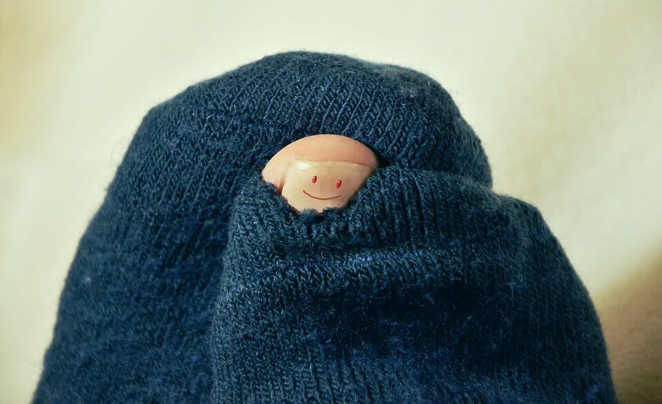 Toe with a smile peeking from socks