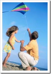 Father and daughter flying a Kite