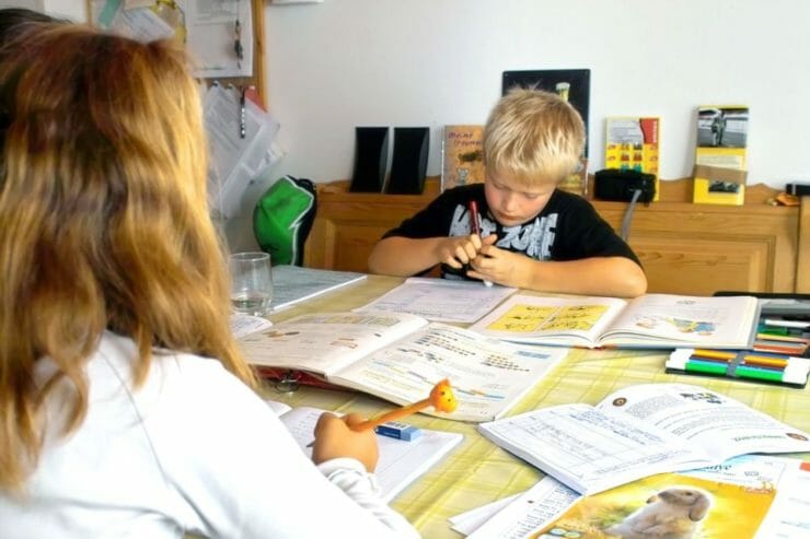 Mother helping boy with homework