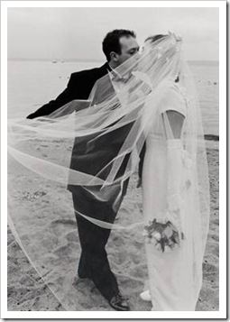 Bride and groom kissing on a beach