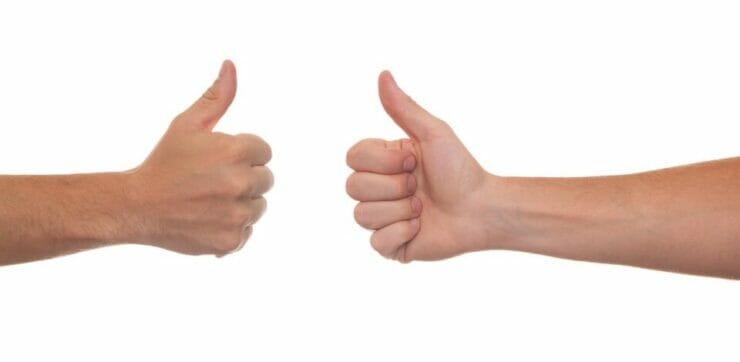 Two hands with thumbs up