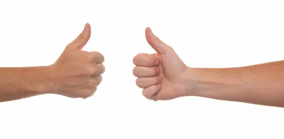Two hands with thumbs up