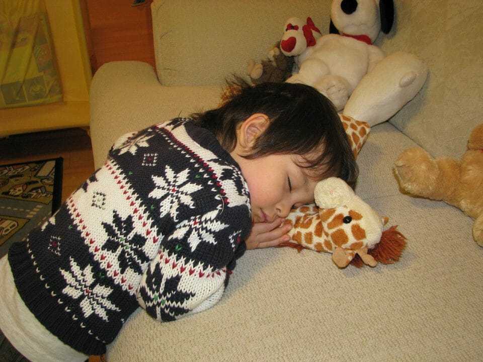 Boy asleep with toys