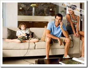 Kid playing video game next to parents