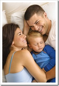 Parents in bed with young child