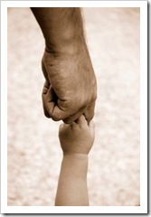 Parent holding hands with baby