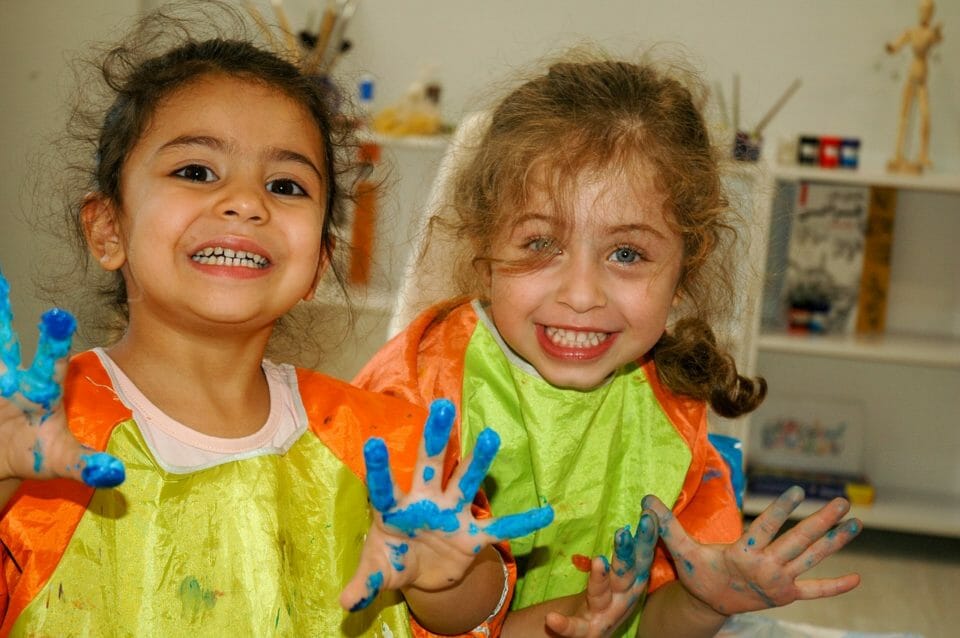 Girls painting with colors