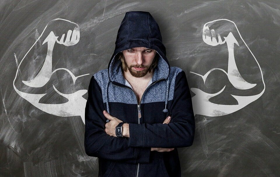 Man with muscly arms drawn behind him