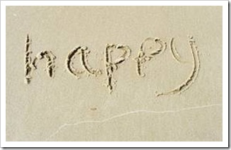 Happy written in sand