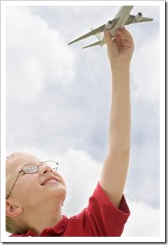 Boy playing with toy plane