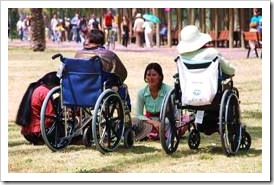 People in wheelchairs with carer
