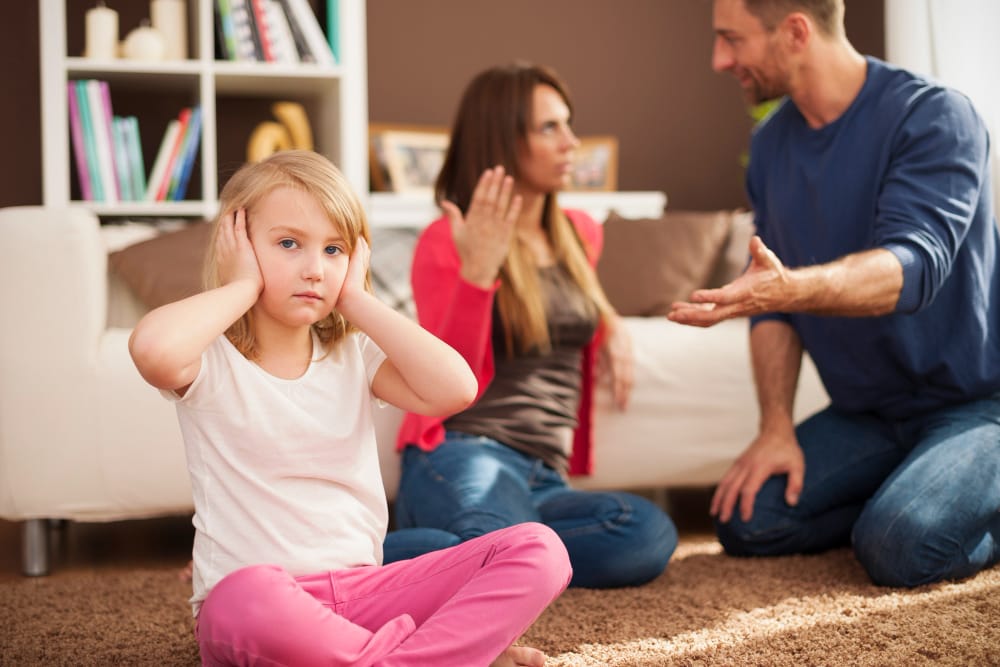 Parents argue while girl blocks her ears