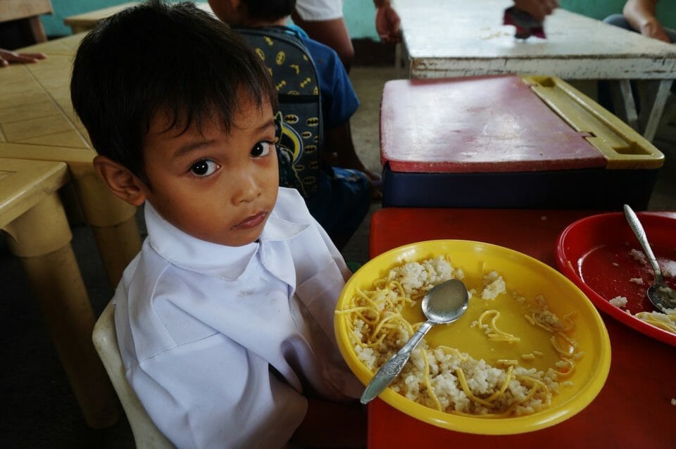 Boy with food left on his plate
