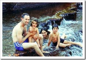 Father and kids on a waterfall