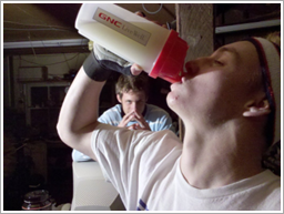 Young man drinking protein shake
