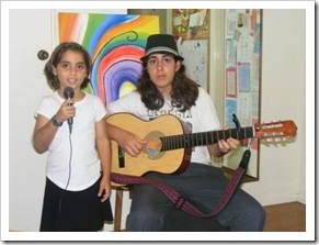 Kids singing and playing guitar