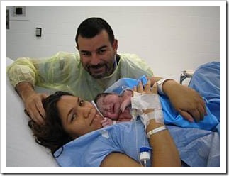 Happy parents and baby after delivery