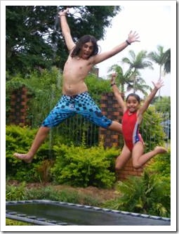 Happy kids bouncing on a trampoline