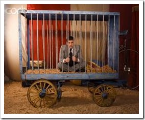 Man in circus cage