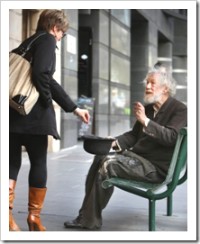 Woman putting money in old man's hat