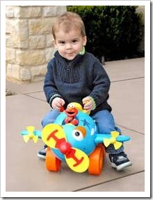 Toddler on toy plane