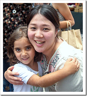 Woman and girl hugging and smiling