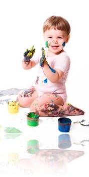 Little boy covered in paint