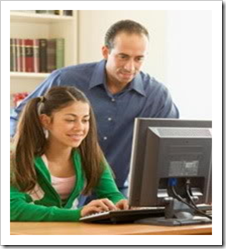 Father looking over daughter's shoulder at computer