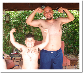 Father and son showing off their muscles