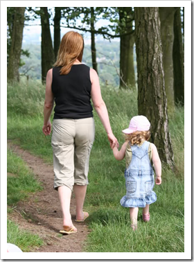 Mother walking with daughter in the woods