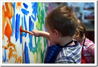 Boy painting on wall
