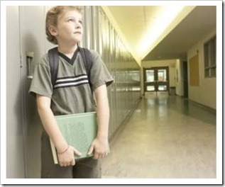 Boy in empty school corridor