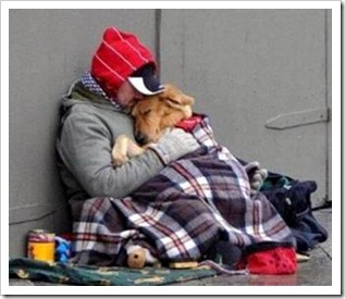 Homeless man hugging his dog